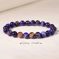 Detailed close-up of natural Sugilite gemstone beads with purple galaxy texture - Galaxy Sugilite