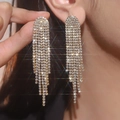 Close-up of luxury gold-plated long tassel earrings with sparkling rhinestones on model - Flat Style / Gold White Zirconia