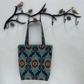 Detail of blue and brown geometric patterned tote bag hanging on a bird design metal hook - Navy Blue