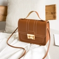 Elegant brown leather crossbody handbag with white contrast stitching and gold lock - Brown