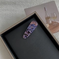 Detail view of purple marble texture hair clip on a minimalist grey display tray - Map Dark Purple Solid Teardrop