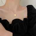 Elegant gold-plated chain necklace featuring a rectangular charm on a female model - Alphabet Square Tag Necklace