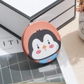Portable round pocket mirror with a cute cartoon penguin illustration on an orange cover - Penguin Head