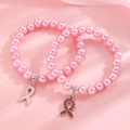 Detailed view of pink pearl bracelets featuring enamel and rhinestone ribbon charms - Gold Pink Ribbon Pearl Bracelet Set (2-Piece) (S210)