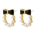 Close-up of golden stud earrings featuring black enamel bows and white pearls - Black (1 Pair)