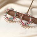 Close-up of multicolored rhinestone sunburst hoop earrings on elegant silk background - Multi-color/KC Gold