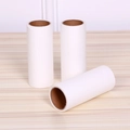 Three white lint roller replacement refills displayed on a light wooden table surface - High Capacity Core / White