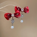 Close-up of red bow earrings with crystal snowflake pendants and white pearls - S925 Silver Pin / Stud Earrings (HE29512) / Red
