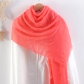Solid red crinkle cotton linen scarf with frayed edges displayed on a white shirt - Red