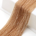 Macro shot of faceted champagne crystal beads on white stand for DIY jewelry making - Amber Gold