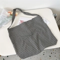 Detailed macro view of the black and white checkered canvas tote bag on a white table - Black White Checkerboard