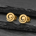Detailed view of gold spiral earrings on dark stone background with minimalist design - Geometric Spiral Gold