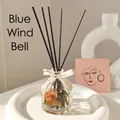 Wild Bluebell reed diffuser with orange dried flowers and black sticks in ribbed glass bottle - 100ml / Bluebell