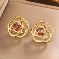 Detailed macro view of vintage gold camellia floral earrings with colorful mosaic center - Gold / Colorful Turquoise