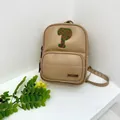 Detail of beige PU backpack featuring green letter embroidery and metal logo plate - Khaki