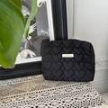Chic black heart-quilted cosmetic bag with branded logo patch and top zipper closure - Black Heart