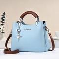 Light blue lychee texture handbag with brown handles and elegant silver logo charm - Blue