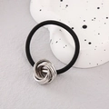 Minimalist black elastic hair tie featuring a silver metal woven knot accessory - Silver Six Interlocking Rings