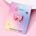 Pink bow enamel brooch with gold metal trim on a decorative display card - Bowknot Shape (087)
