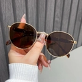 Detailed close-up of retro round gold metal sunglasses with dark brown polarized lenses - Gold Frame Tea Lens