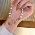 Detail of baroque freshwater pearl bracelet with a gold lucky cat zircon charm - Gold Lucky Cat Style