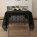 Elegant black lace tablecloth with geometric patterns and fringe edges on a dining table - Black Crochet Diamond