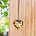 Amber heart-cut crystal suncatcher pendant hanging on a delicate black cord - 30MM / Champagne