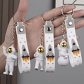 Astronaut keychain set with golden visors and white wrist straps on lunar motifs - No.2 Gold 3-Piece Keychain Set (White Strap)