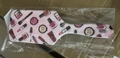 Pink handheld mirror with cute cosmetics print packaged in transparent polybag - Red Background Makeup Tools