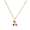 Close-up of gold cherry pendant with red heart gemstone and green leaf crystal - Gold Heart Cherry Necklace