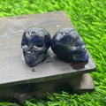 Mini hand-carved dark blue natural stone crystal skulls set on a wood base - Blue Sodalite