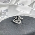 Macro shot of silver snake ring with scale textures and black head featuring clear crystal - No. 20 Open Ring
