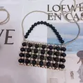 Detail of beaded handbag showing metal chain and capacity for a smartphone - Large Extended / Black