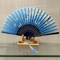 Blue gradient folding fan with white cherry blossoms, butterfly motifs, and a tassel - Little Daisy (Blue)