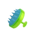 Green handheld scalp massager brush with blue silicone bristles and suction base design - Dual Tone Translucent Cyan