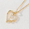 Macro shot of gold heart pendant with white zircon and MOM cutout lettering - Heart MOM Hollow/White Zirconia