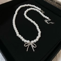 Elegant white pearl necklace with a silver bow pendant and adjustable lobster clasp - White with Bowknot