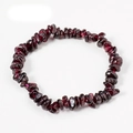 Macro detail of handmade natural garnet irregular stone bracelet with deep red crystal texture - Garnet