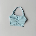 Detail of ruched center and halter neck design on a light blue sports bra top - Baby Blue