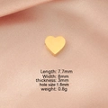 Macro shot of gold heart pendant with dimensions 7.7x8mm on pink silk background - 8*8mm Heart-Shaped Bead with Small Hole / Gold