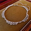 Macro detail of silver lace pattern necklace with crystals on green velvet display - Silver Tone Rhinestone Lace Pattern Necklace