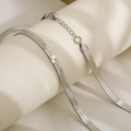 Close-up of silver stainless steel flat snake chain with lobster clasp and extender - 5mm Width 40cm Length / Silver