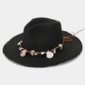 Detail of black straw hat featuring shell decorations and a frayed brim for summer - One Size / Black