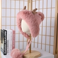 Pink plush earmuff hat with cute brown antlers and double pom-poms on a mannequin - Antler Ear Flap Plush Hat / Pink