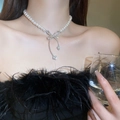 Elegant pearl choker necklace featuring a sparkling rhinestone bow pendant on a model - Pearl Rhinestone Bow Necklace