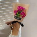 Rosa Seifenrosenstrauß mit drei Blumen in oranger Verpackung und schwarzer Schleife - Fuchsia