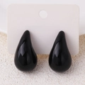 Glossy black teardrop earrings in water drop shape mounted on a white jewelry card - Black