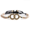 Detail of interlocking micro-pave rings on a tricolor bead woven adjustable bracelet - Gold Double Ring + Tricolor Mixed Beads + Black Rope