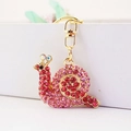 Simpatico portachiavi a lumaca dorato con strass rosa e chiusura a moschettone - Rosa