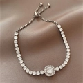 Elegant silver adjustable square diamond bracelet with central sunburst floral charm - Silver